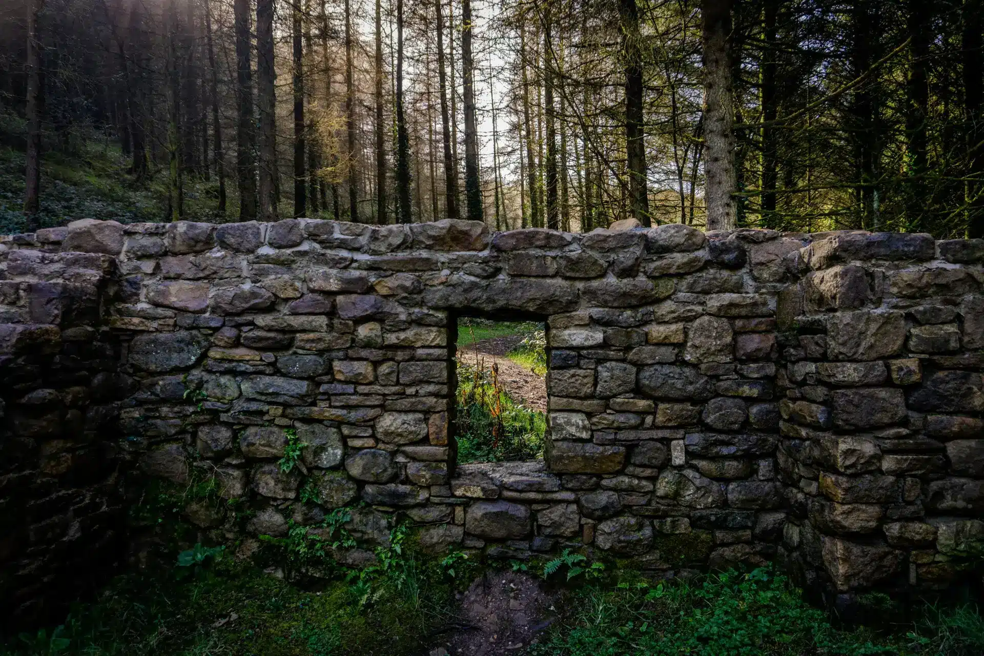 A stone wall with a mirror in the middle of it